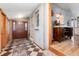 The foyer features a tiled floor, decorative niches, and an adjacent wood cabinet at 23136 Kiowa Rd, Indian Hills, CO 80454