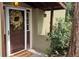 Inviting front door with glass panel, decorative wreath, and 'Welcome' mat at 23136 Kiowa Rd, Indian Hills, CO 80454