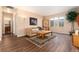 Cozy living room showcasing hardwood flooring and natural lighting at 23136 Kiowa Rd, Indian Hills, CO 80454