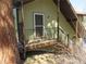 View of the porch with a door, railings, and wooden support beams at 23136 Kiowa Rd, Indian Hills, CO 80454