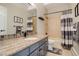 Guest bathroom with granite countertop and tub shower combo at 334 Humphrey Dr, Evergreen, CO 80439