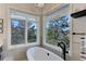 Luxurious bathroom with soaking tub and mountain views at 334 Humphrey Dr, Evergreen, CO 80439