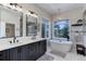 Luxurious bathroom with double vanity, soaking tub, and walk-in shower at 334 Humphrey Dr, Evergreen, CO 80439