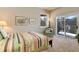 Cozy bedroom with a view and sliding door access to deck at 334 Humphrey Dr, Evergreen, CO 80439