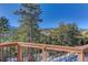 Deck with mountain views and railing at 334 Humphrey Dr, Evergreen, CO 80439