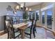 Elegant dining room with large windows, mountain views and a chandelier at 334 Humphrey Dr, Evergreen, CO 80439
