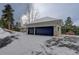 Two-car garage with dark-colored doors and snowy driveway at 334 Humphrey Dr, Evergreen, CO 80439