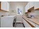 Bright laundry room with washer, dryer and cabinets at 334 Humphrey Dr, Evergreen, CO 80439