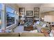 Large living room with a stone fireplace and expansive windows showcasing mountain views at 334 Humphrey Dr, Evergreen, CO 80439