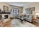 Cozy living room features a fireplace, bay window, and comfortable seating at 334 Humphrey Dr, Evergreen, CO 80439