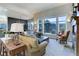 Living room with large windows, mountain views, and a fireplace at 334 Humphrey Dr, Evergreen, CO 80439