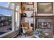 Cozy living room featuring a fireplace, large windows, and mountain views at 334 Humphrey Dr, Evergreen, CO 80439
