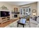 Living room with fireplace, large TV, and ample natural light at 334 Humphrey Dr, Evergreen, CO 80439