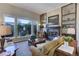 Spacious living room with a fireplace, built-in shelving, and mountain views at 334 Humphrey Dr, Evergreen, CO 80439