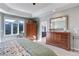 Bright main bedroom with large windows, dresser, and walk-in closet at 334 Humphrey Dr, Evergreen, CO 80439