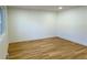 Empty living room with light wood floors and white walls at 14023 E Utah Cir, Aurora, CO 80012