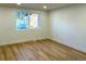 Bright living room with light wood floors and white walls at 14023 E Utah Cir, Aurora, CO 80012