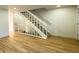 Indoor staircase with white railing and light wood floors at 14023 E Utah Cir, Aurora, CO 80012