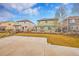 Large backyard with mature trees, privacy fence, patio area, and lush green grass, perfect for outdoor activities at 15112 E 116Th Pl, Commerce City, CO 80603