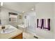 Bright bathroom features double sinks, a soaking tub, and a glass shower enclosure at 15112 E 116Th Pl, Commerce City, CO 80603