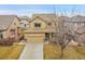 Charming two-story home with a well-manicured lawn, a two-car garage, and a welcoming front porch at 15112 E 116Th Pl, Commerce City, CO 80603