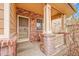 Welcoming front porch with brick columns and a secure screen door at 15112 E 116Th Pl, Commerce City, CO 80603