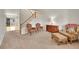Cozy living room features carpeted floors, staircase and a welcoming seating area at 15112 E 116Th Pl, Commerce City, CO 80603