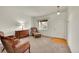 Comfortable living room with carpet and a front door at 15112 E 116Th Pl, Commerce City, CO 80603