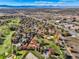 Aerial view of neighborhood with golf course and mountain backdrop at 11854 Vallejo St, Denver, CO 80234