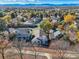 Aerial view of neighborhood with autumn foliage and mountains at 11854 Vallejo St, Denver, CO 80234