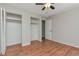 Bedroom featuring spacious closets, laminate flooring, and neutral paint for a comfortable and bright atmosphere at 5700 W 28Th Ave # 6, Wheat Ridge, CO 80214