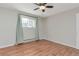 Bedroom with laminate flooring, neutral walls, a ceiling fan, and a window with light-filtering blinds at 5700 W 28Th Ave # 6, Wheat Ridge, CO 80214