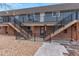 Apartment building featuring staircases to upper-level units, rock landscaping, and brick accents at 5700 W 28Th Ave # 6, Wheat Ridge, CO 80214