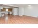 Bright living room with wood-look flooring, and a view of the kitchen featuring a rustic wood plank wall at 5700 W 28Th Ave # 6, Wheat Ridge, CO 80214