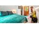 Bright bedroom featuring unique furnishings, sloped ceilings, a colorful rug, and natural light at 7364 Rossman Gulch Rd, Morrison, CO 80465