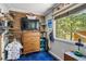 Bedroom features a large window with natural light, hardwood floors, and a modern decor at 7364 Rossman Gulch Rd, Morrison, CO 80465