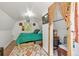 Charming bedroom with bright white walls, sloped ceilings, unique rug and colorful accents at 7364 Rossman Gulch Rd, Morrison, CO 80465