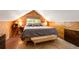 Comfortable bedroom with wooden paneling, natural light, and built-in side tables at 7364 Rossman Gulch Rd, Morrison, CO 80465