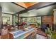Open concept dining area featuring a wood-burning stove, natural light, and seamless flow to living spaces at 7364 Rossman Gulch Rd, Morrison, CO 80465