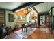 Inviting dining room with ample natural light, wood accents, and a cozy wood-burning stove at 7364 Rossman Gulch Rd, Morrison, CO 80465