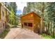 Rustic wooden cabin featuring a red door and large windows at 7364 Rossman Gulch Rd, Morrison, CO 80465