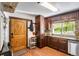 Cozy kitchen with ample cabinet space, modern appliances, and rustic wood accents at 7364 Rossman Gulch Rd, Morrison, CO 80465