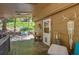 Inviting covered porch with wood decking, outdoor seating, and charming decorative touches at 7364 Rossman Gulch Rd, Morrison, CO 80465