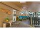 Relaxing covered porch with comfortable outdoor furniture and a view of the wooded landscape at 7364 Rossman Gulch Rd, Morrison, CO 80465
