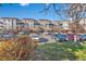 Exterior shot of the home with a parking lot filled with vehicles in front of the apartment building at 15475 Andrews Dr # 314, Denver, CO 80239