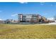 Modern apartment building with large windows and balconies, surrounded by a beautifully maintained lawn at 15475 Andrews Dr # 314, Denver, CO 80239