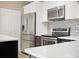 Close-up of the well-equipped kitchen with stainless steel appliances and tiled backsplash at 15475 Andrews Dr # 314, Denver, CO 80239
