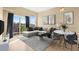 Bright living room with a comfortable couch and a view of the private balcony at 15475 Andrews Dr # 314, Denver, CO 80239