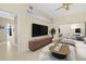 Comfortable living room showcasing stylish furniture, a large tv, and light-colored wooden floors at 15475 Andrews Dr # 314, Denver, CO 80239