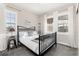 Serene bedroom featuring a stylish black metal bed frame with lots of natural light from the bright windows at 11582 Jimenez St, Parker, CO 80134